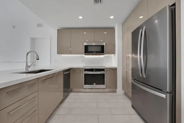 a kitchen with a refrigerator and a sink