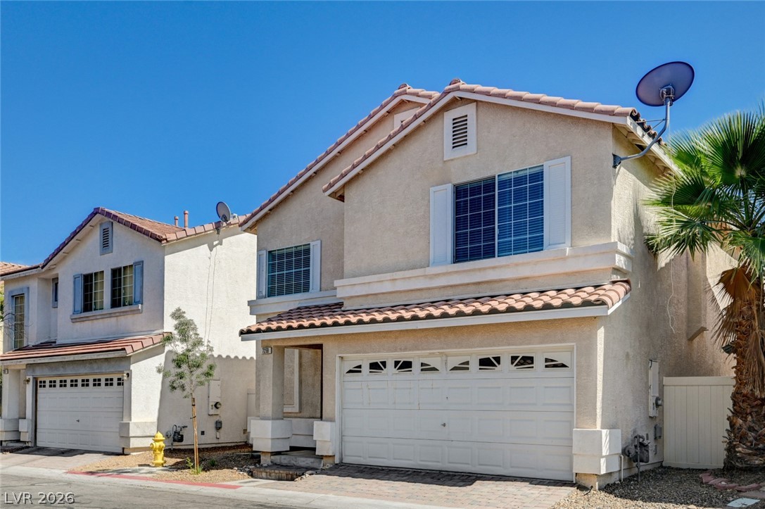 7259 Cestrum Road Las Vegas, NV 89113 - Photo 2 of 35 A cream-colored stucco exterior with a tiled roof provides a pleasing curb appeal under a clear blue sky.