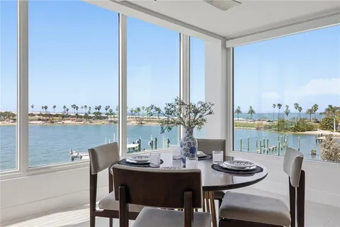 a kitchen with a dining table chairs and view living room