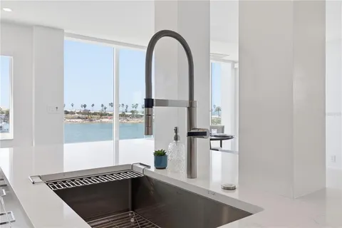 a kitchen with a sink and a stove top oven