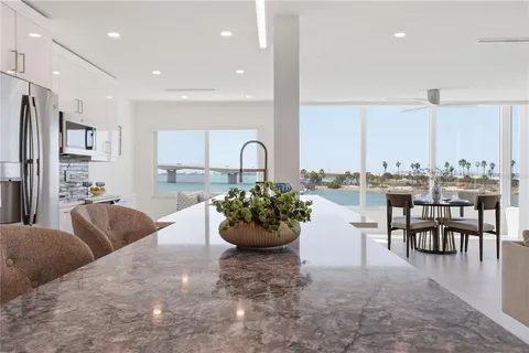 a living room with furniture and view of kitchen