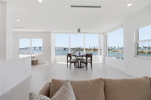 a kitchen with stainless steel appliances a refrigerator and wooden floor
