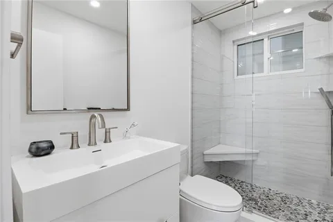 a bathroom with a toilet and a shower