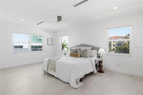 a spacious bedroom with a bed and a window