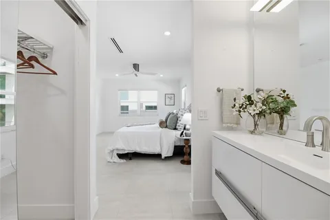 a bathroom with a shower a sink and a mirror