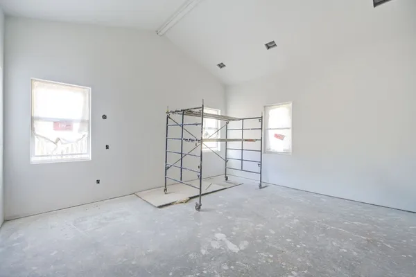 a view of a livingroom with a ceiling fan & hardwood floor