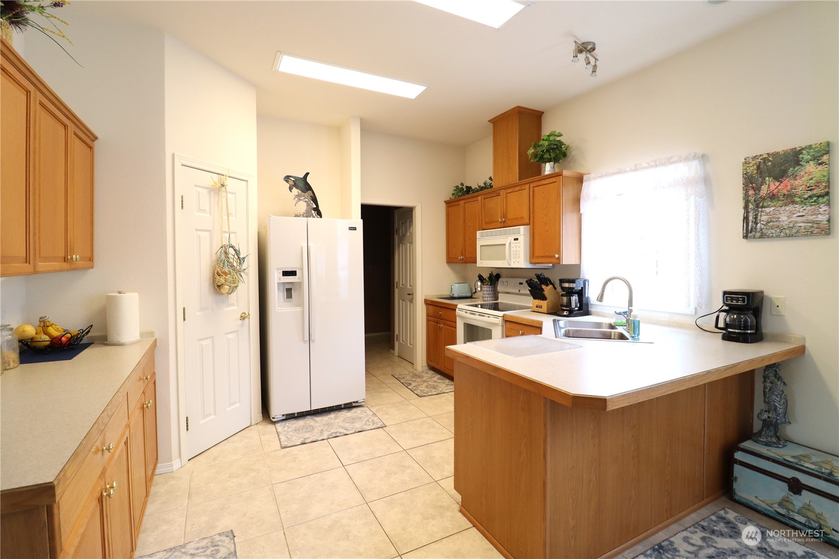 128 Aylesworth Road, Unit 4 Chehalis, WA 98532 - Photo 10 of 24 a large white kitchen with a sink a refrigerator and a stove