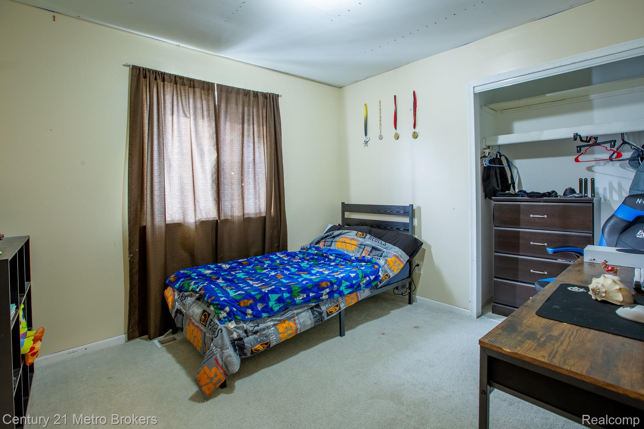 6101 Belsay Road Grand Blanc, MI 48439 - Photo 6 of 28 Bedroom with light carpet and baseboards