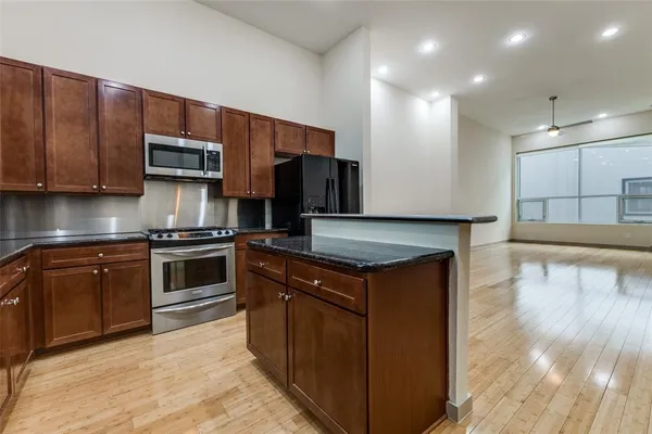 a kitchen with a sink a stove and cabinets