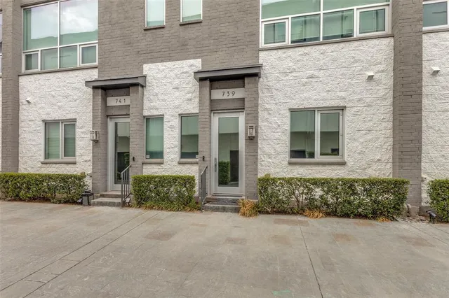 front view of a brick house with a large windows
