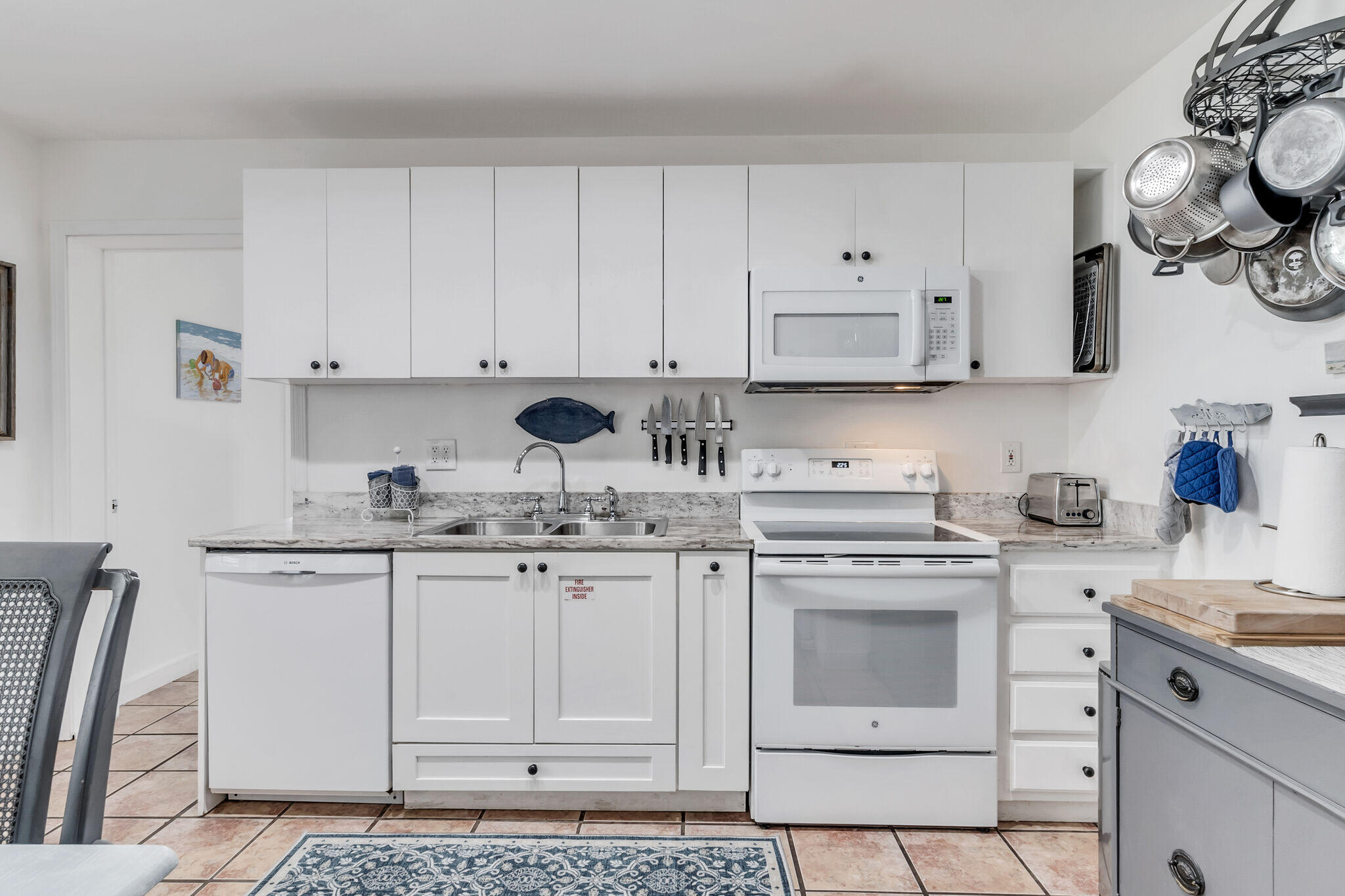 44 Vicki Street Santa Rosa Beach, FL 32459 - Photo 12 of 41 a kitchen with granite countertop white cabinets white stainless steel appliances with a sink and dishwasher