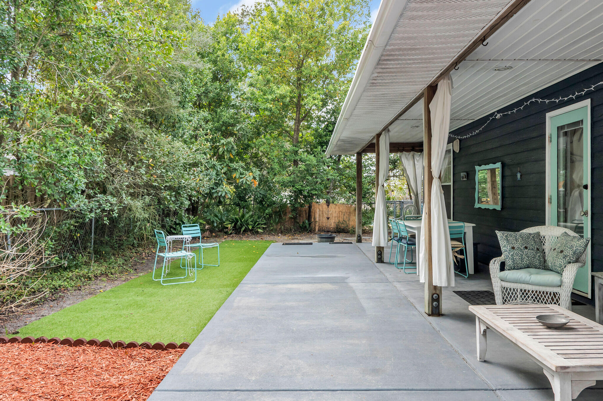44 Vicki Street Santa Rosa Beach, FL 32459 - Photo 28 of 41 a view of a patio with a table and chairs next to a yard