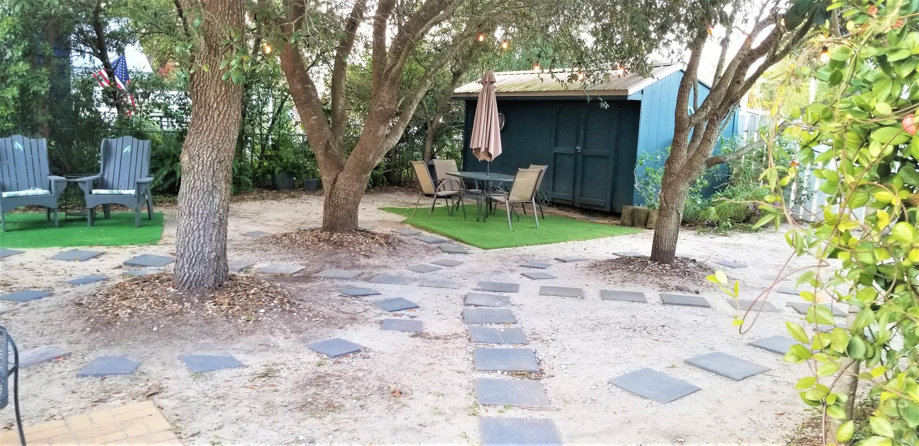 44 Vicki Street Santa Rosa Beach, FL 32459 - Photo 39 of 41 a view of backyard with a barn and a large tree