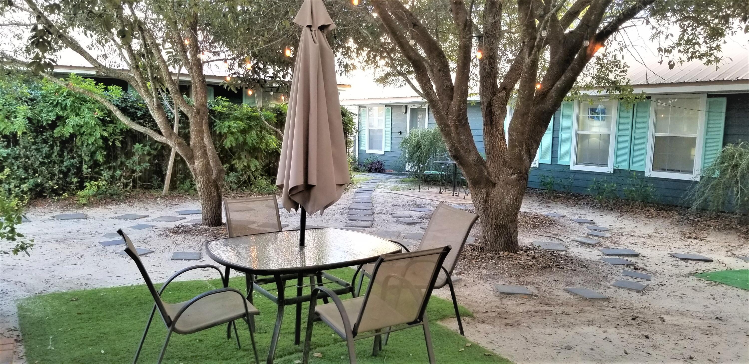 44 Vicki Street Santa Rosa Beach, FL 32459 - Photo 4 of 41 a view of a chairs and table in backyard