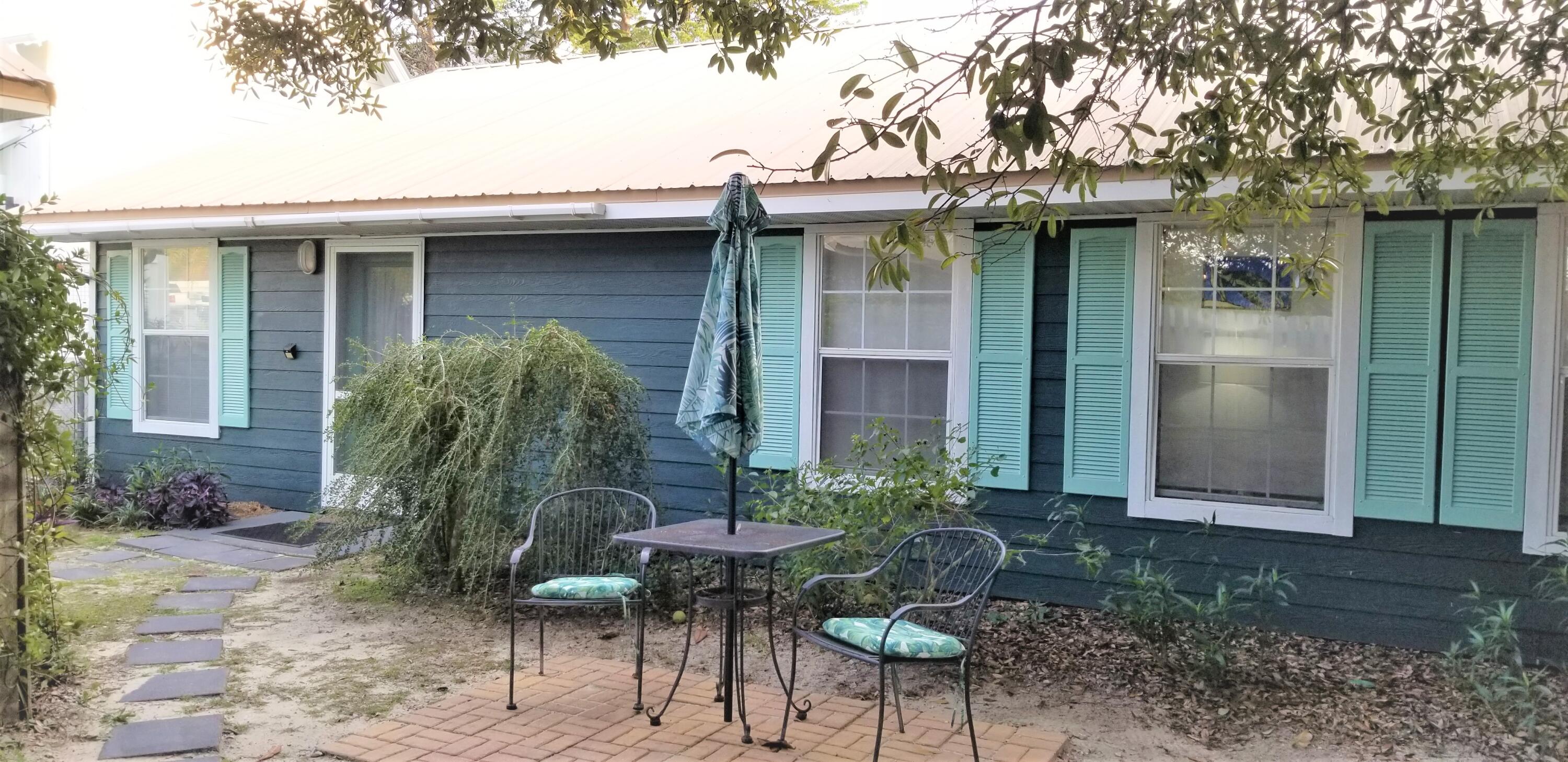 44 Vicki Street Santa Rosa Beach, FL 32459 - Photo 8 of 41 a view of a chair and table in backyard of the house