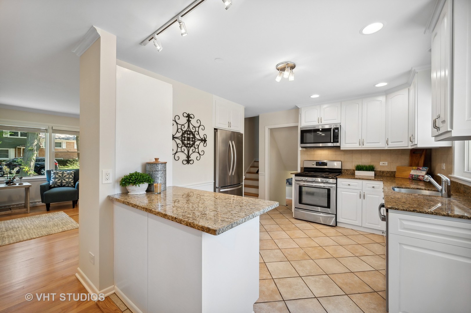740 Juniper Road Glenview, IL 60025 - Photo 7 of 22 a kitchen with granite countertop a sink counter top space appliances and cabinets