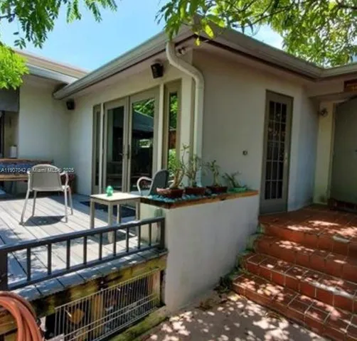 a view of balcony with two chairs and a table