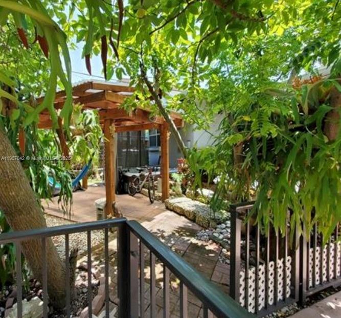 6918 Northeast 5th Avenue Miami, FL 33138 - Photo 2 of 9 a view of a wooden chairs and table in the balcony