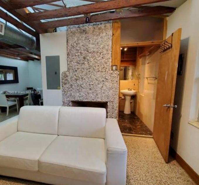 6918 Northeast 5th Avenue Miami, FL 33138 - Photo 3 of 9 a living room with a couch and a refrigerator