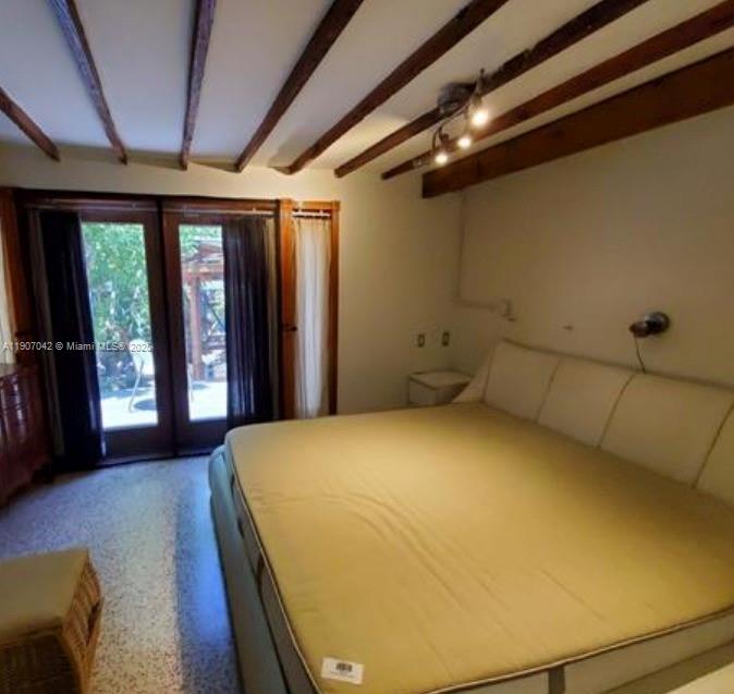 6918 Northeast 5th Avenue Miami, FL 33138 - Photo 7 of 9 a bedroom with a bed and large windows