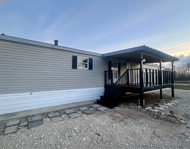 a view of a deck with a bench and wooden floor