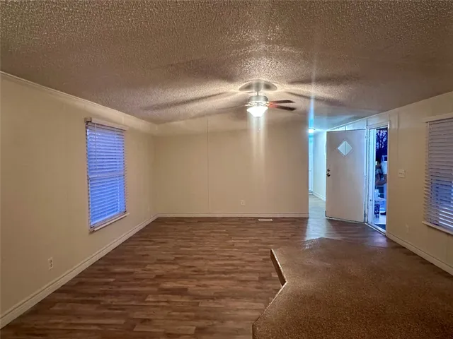a view of a room with a staircase and a ceiling fan