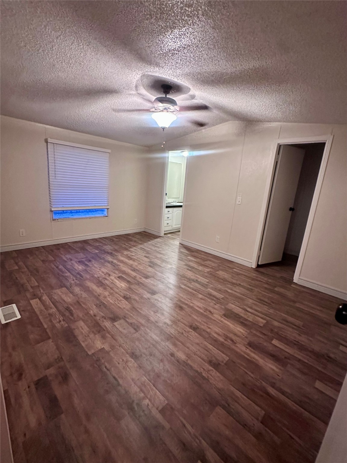 13630 FM 361 Road, Unit B Needville, TX 77461 - Photo 5 of 12 an empty room with wooden floor and windows