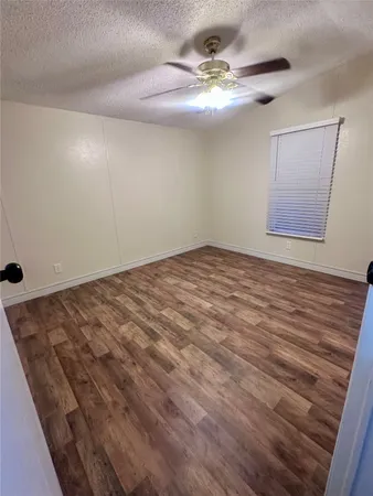 a view of a room with a ceiling fan