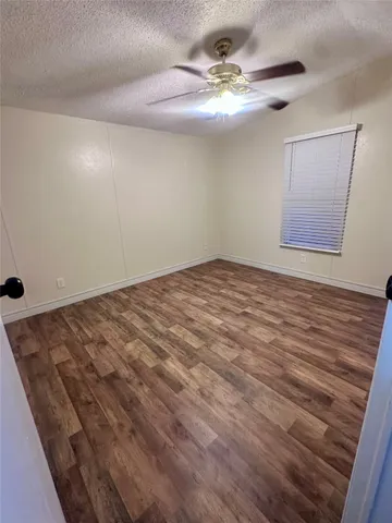 a view of a room with a ceiling fan