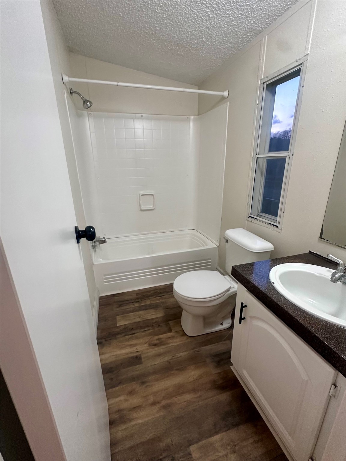 13630 FM 361 Road, Unit B Needville, TX 77461 - Photo 10 of 12 a bathroom with a sink a toilet a mirror and shower