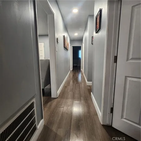a view of hallway with wooden floor