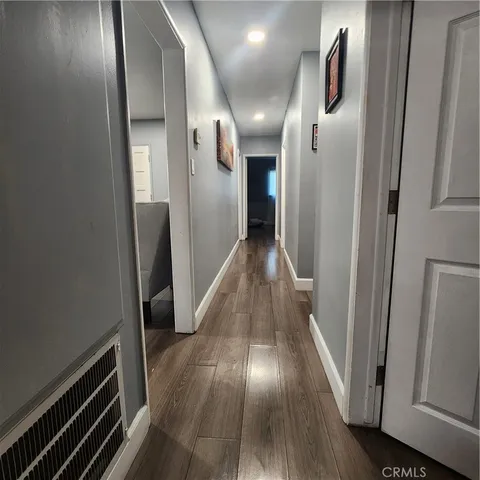 a view of hallway with wooden floor