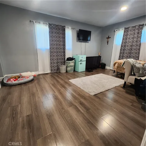 a bedroom with a bed and a flat screen tv