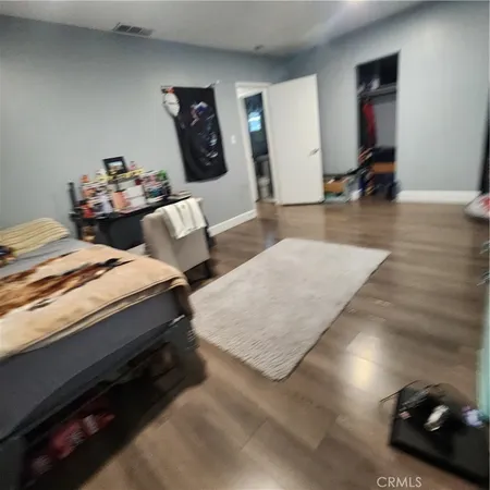 a bedroom with two beds and a couch