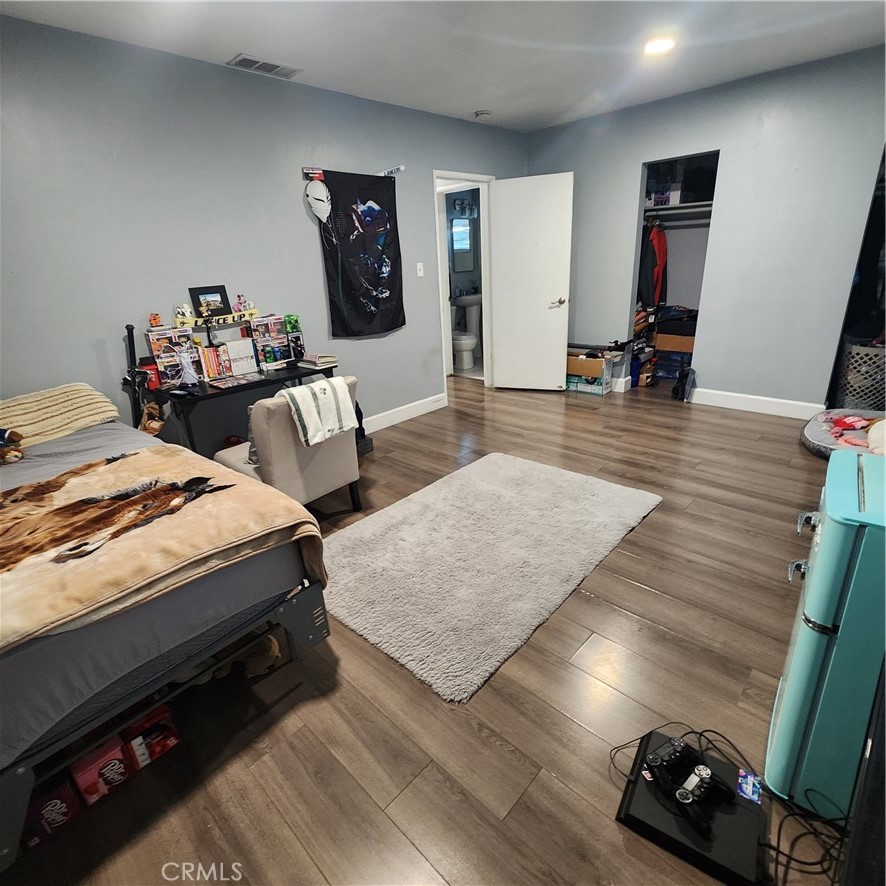 3076 Ronald Street Riverside, CA 92506 - Photo 16 of 19 a bedroom with furniture and wooden floor