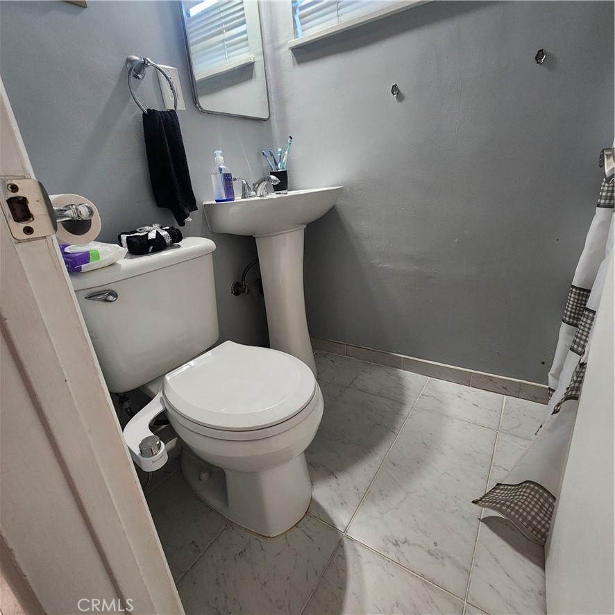 3076 Ronald Street Riverside, CA 92506 - Photo 18 of 19 a white toilet sitting next to a bathroom sink