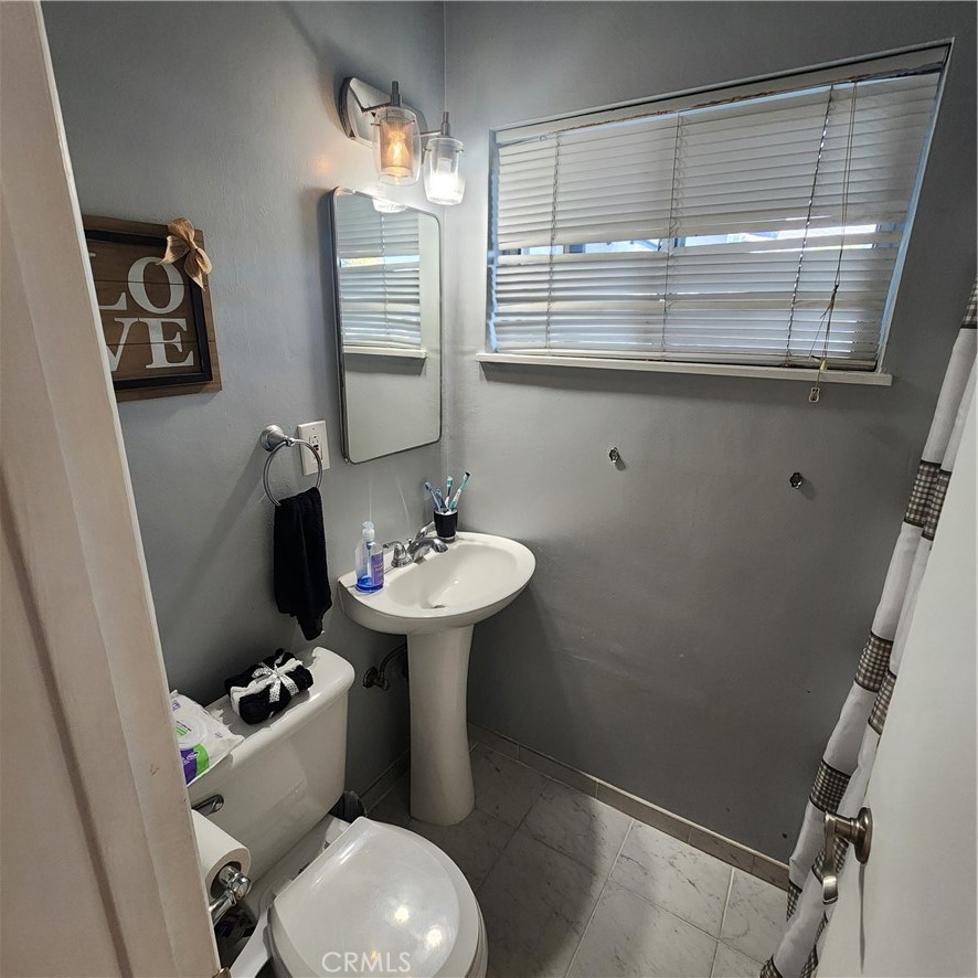 3076 Ronald Street Riverside, CA 92506 - Photo 19 of 19 a bathroom with a sink toilet and shower