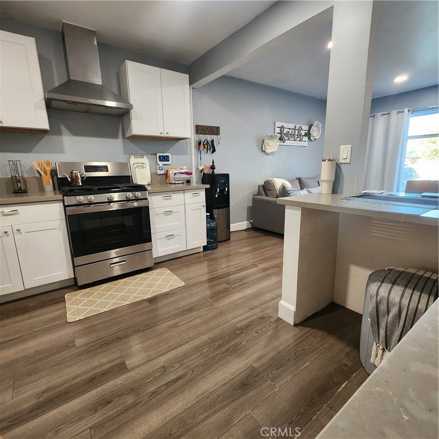 3076 Ronald Street Riverside, CA 92506 - Photo 3 of 17 a kitchen with stainless steel appliances a stove a sink and a refrigerator