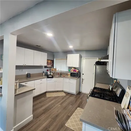 a kitchen with sink refrigerator and stove
