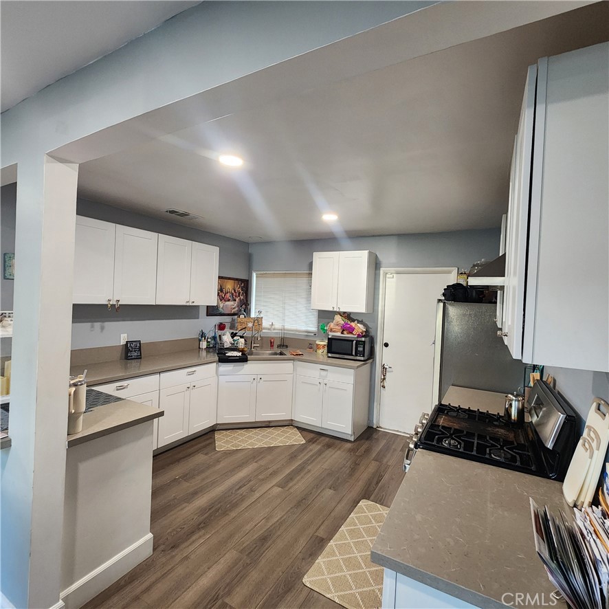 3076 Ronald Street Riverside, CA 92506 - Photo 4 of 17 a kitchen with sink refrigerator and stove