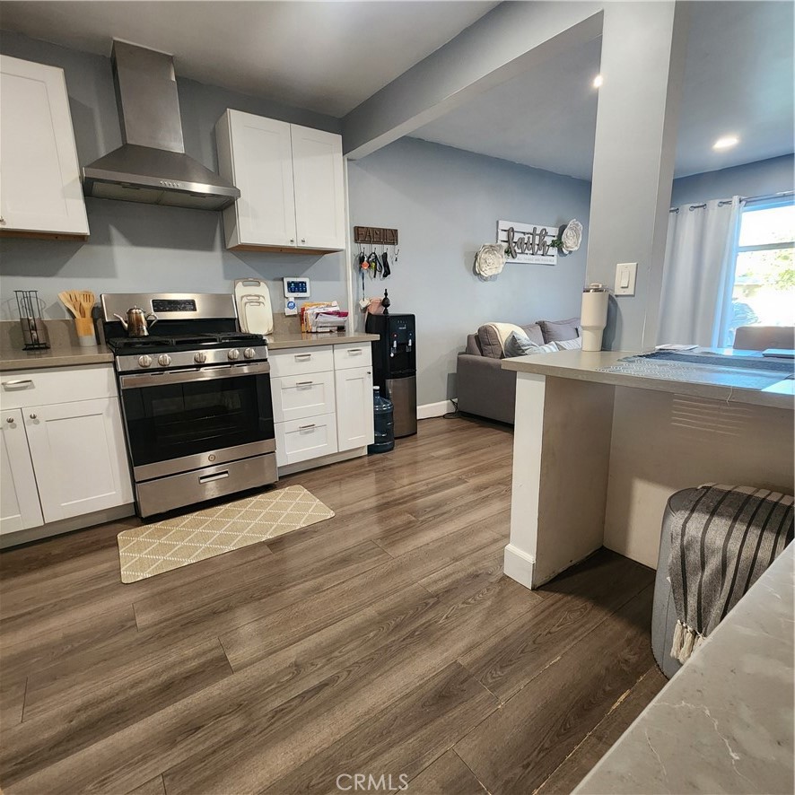 3076 Ronald Street Riverside, CA 92506 - Photo 6 of 19 a kitchen with stainless steel appliances a stove a sink and a refrigerator
