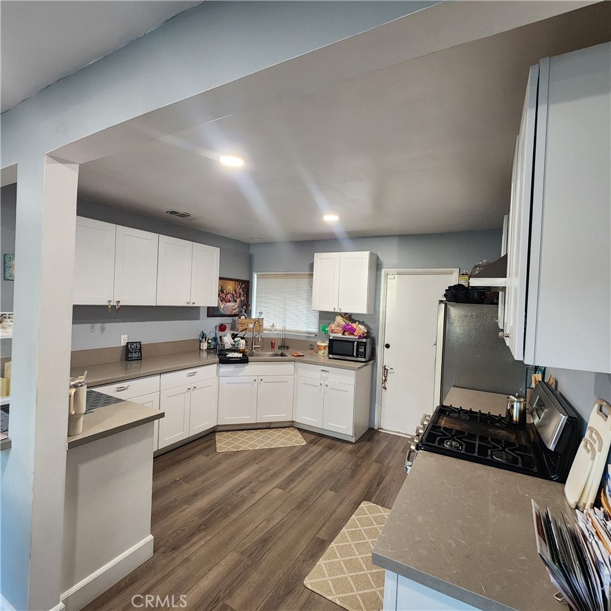 3076 Ronald Street Riverside, CA 92506 - Photo 7 of 19 a kitchen with sink refrigerator and stove