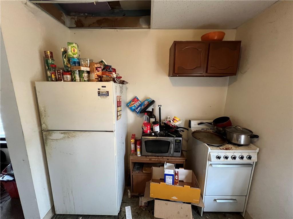 519 Roup Street Tarentum, PA 15084 - Photo 5 of 13 a white refrigerator freezer and a stove sitting inside of a kitchen