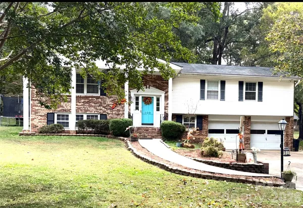 a view of a house with swimming pool and sitting area