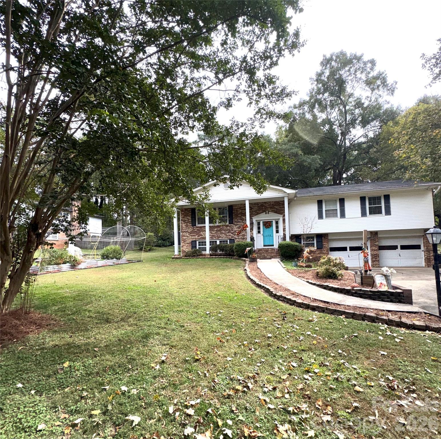 109 Churchill Road Dallas, NC 28034 - Photo 2 of 40 a front view of a house with a yard table and chairs