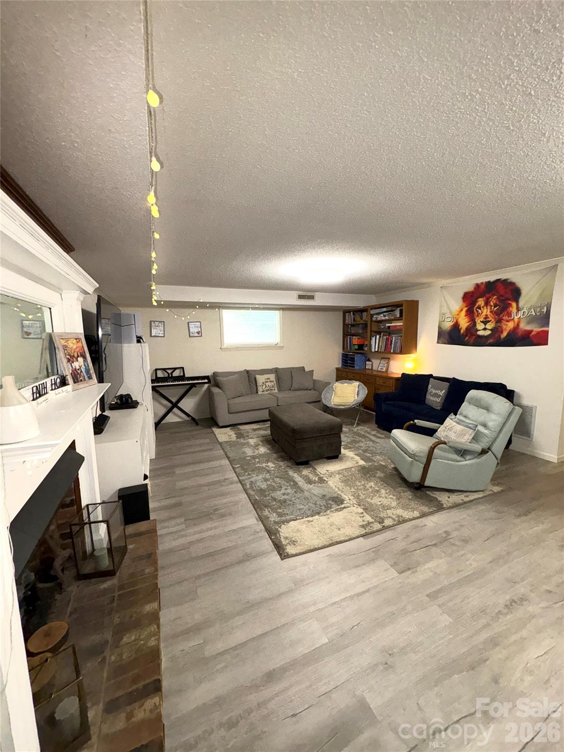 109 Churchill Road Dallas, NC 28034 - Photo 23 of 40 a living room with furniture and a lamp