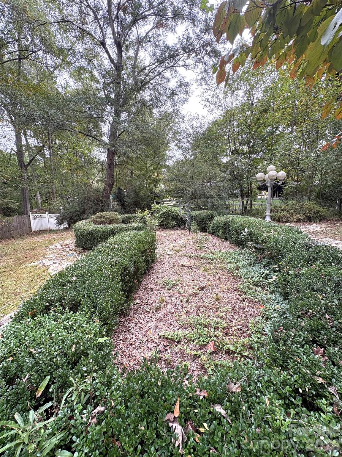 109 Churchill Road Dallas, NC 28034 - Photo 33 of 40 a backyard of a house with lots of green space and plants