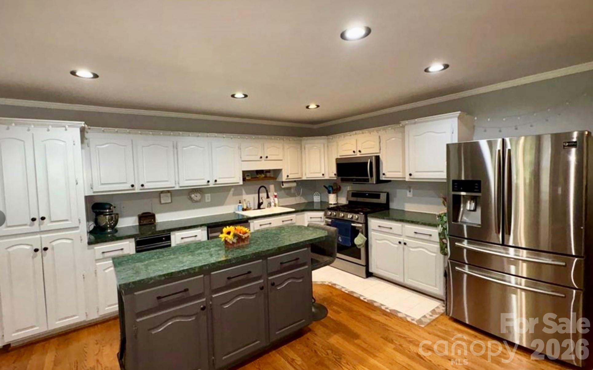 109 Churchill Road Dallas, NC 28034 - Photo 9 of 40 a kitchen with stainless steel appliances granite countertop a refrigerator sink and stove