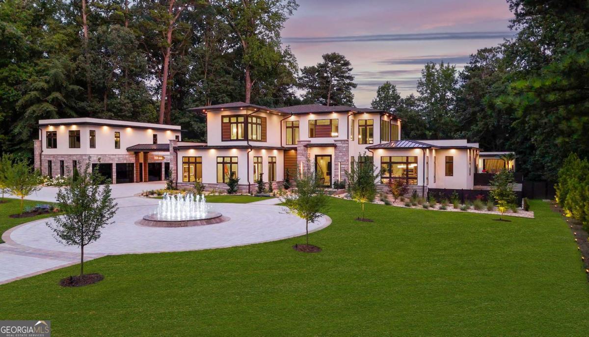 1386 Moores Mill Road Northwest Atlanta, GA 30327 - Photo 1 of 58 a front view of a house with a garden