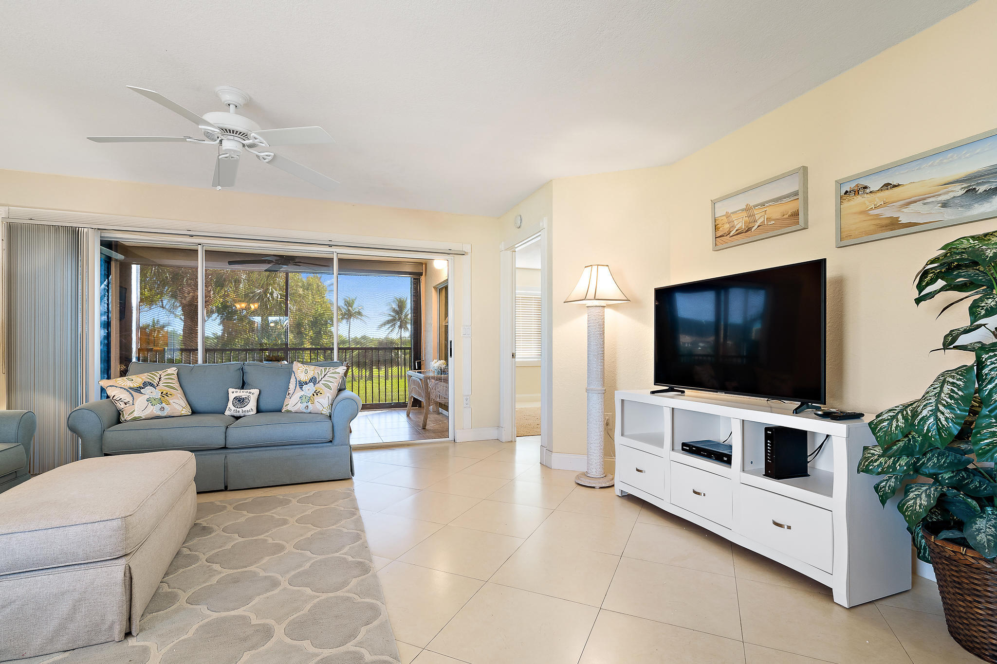 275 Palm Avenue, Unit C201 Jupiter, FL 33477 - Photo 13 of 24 a living room with furniture and a flat screen tv